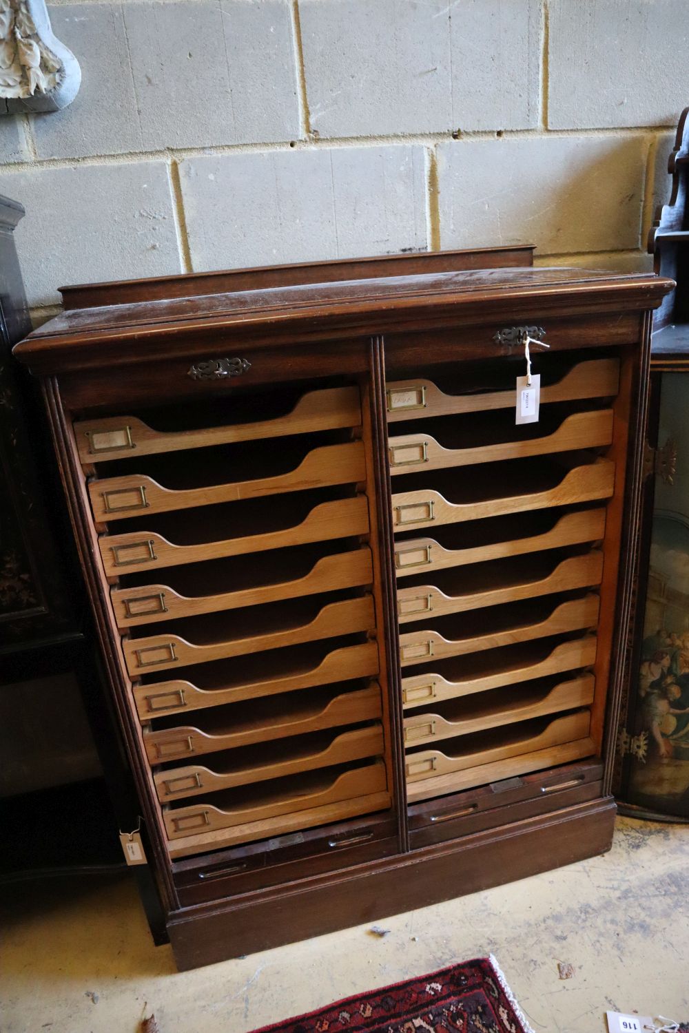 A walnut double tambour filing cabinet, circa 1935, fitted sliding trays, width 90cm, depth 42cm, height 116cm